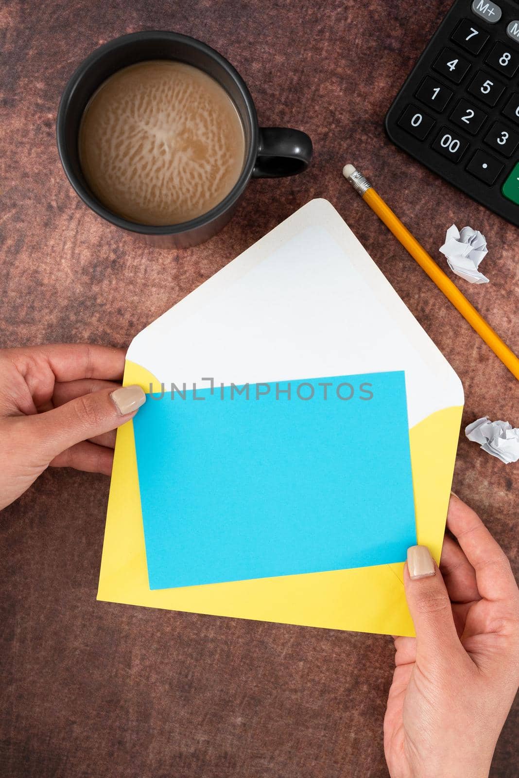 Woman Holding Blank Letter With Coffee And Stationery Over Wood.