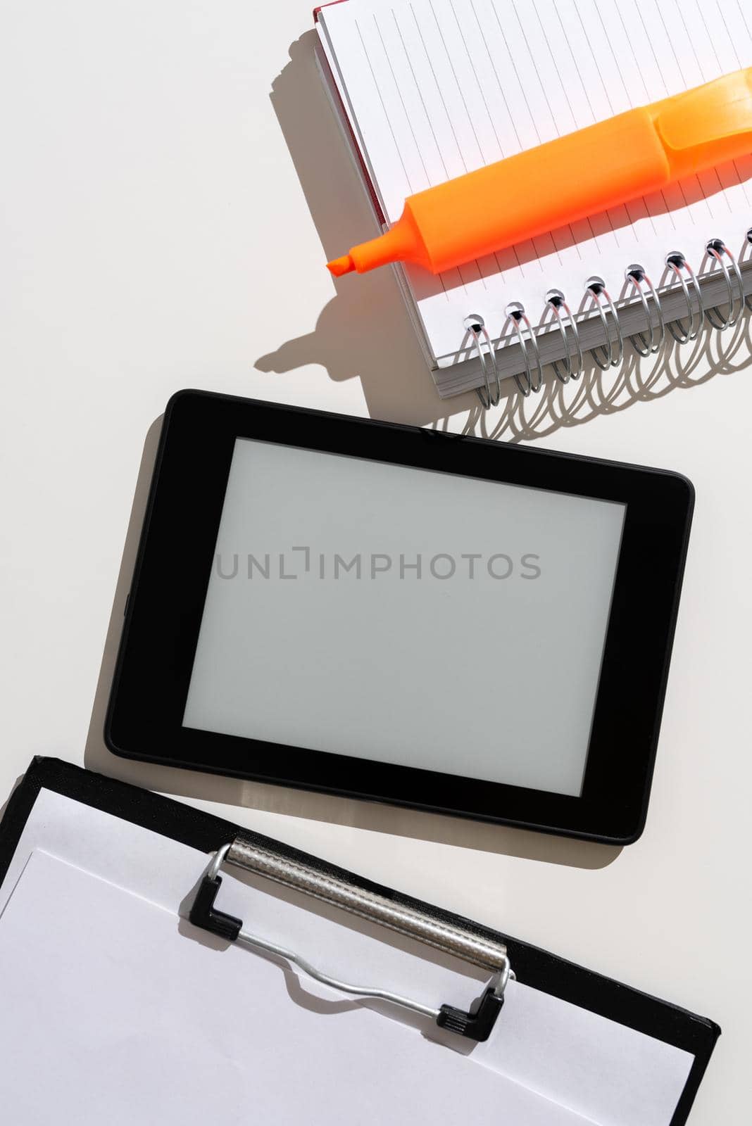 Tablet With Important Message Between Clipboard, Notebook And Marker.