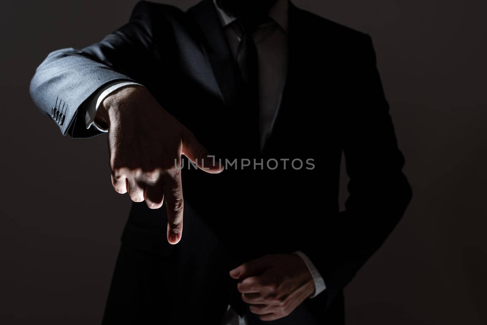 Businessman Pointing With One Finger On Important Messages. Executive In Suit Presenting Crutial Informations. Gentleman Showing Critical Announcement. by nialowwa