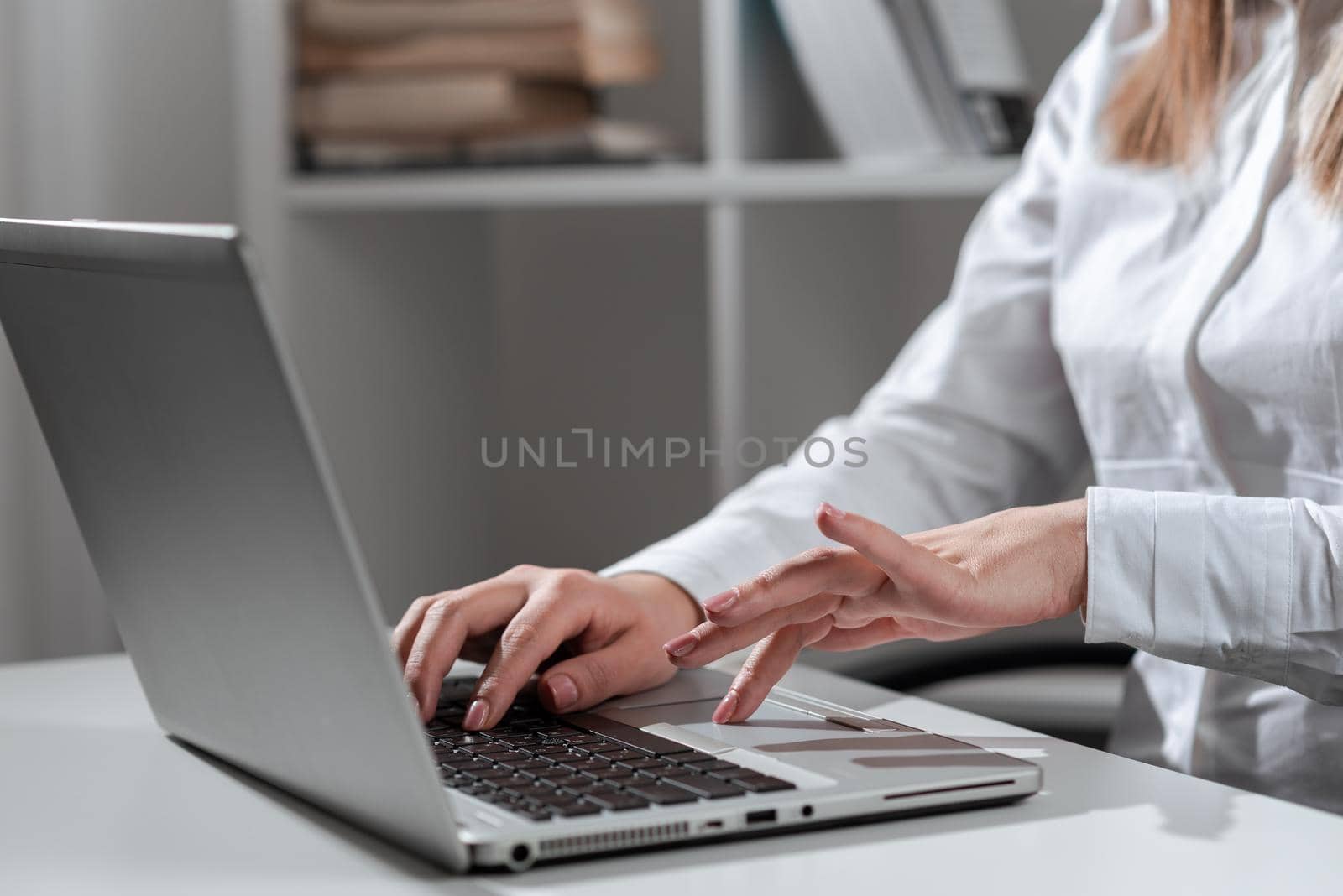 Businesswoman Typing Recent Updates On Lap Top Keyboard On Desk.