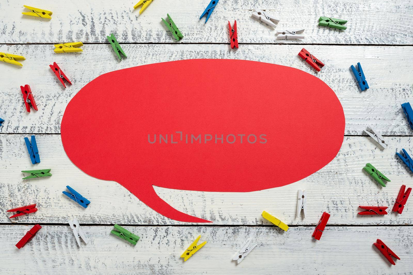 Colorful Pegs Placed Around Speech Bubble With Important Information.