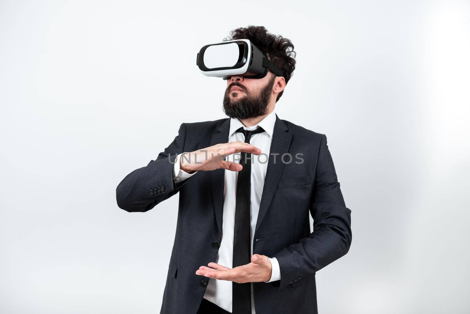 Man Wearing Vr Glasses And Presenting Important Messages Between Hands. Businessman Having Virtual Reality Eyeglasses And Showing Crutial Informations. by nialowwa