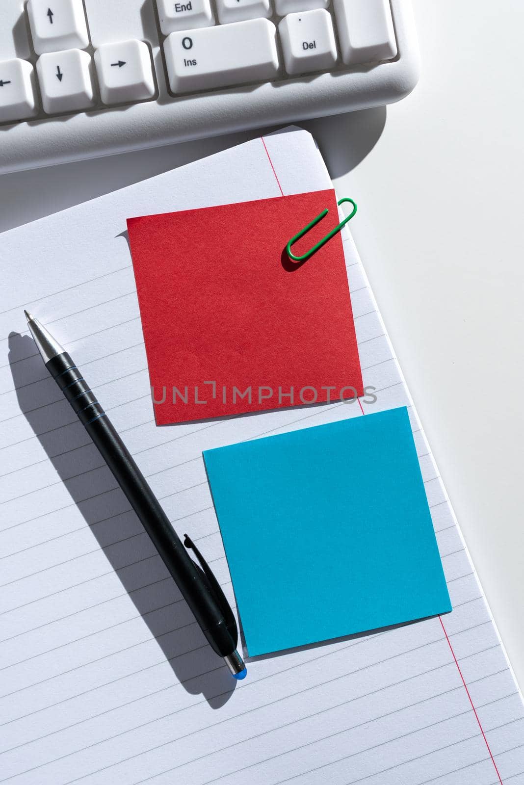 Sticky Notes With Important Ideas Clipped On Notebook On Desk With Pen.