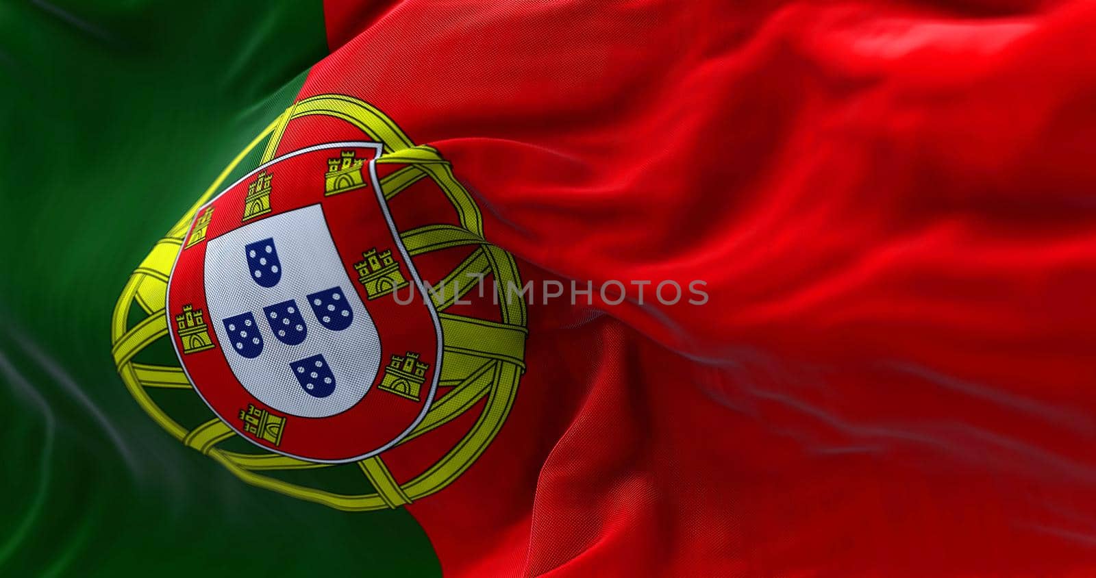 Close-up view of Portugal national flag waving in the wind. Portugal is an European country located in western Europe. Fabric background