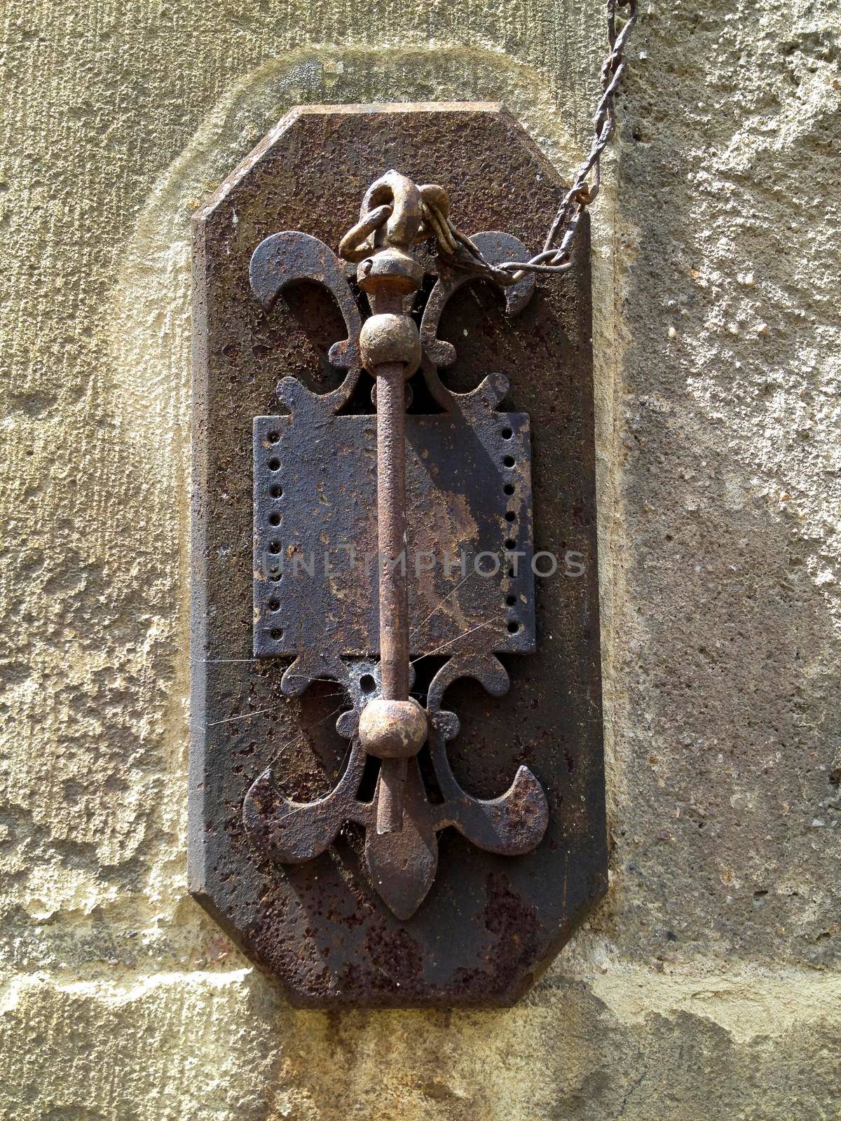 old rusty key hanging on the stone wall