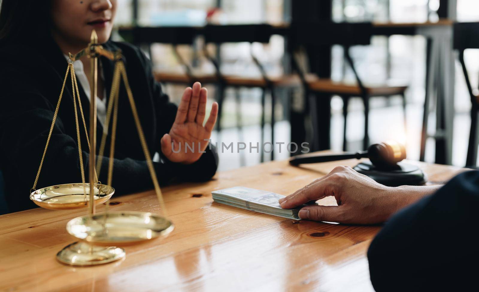 Close-up view of a lawyer refusing graft from a client, make a deal agreement corruption, Judge gavel, brass scale, law firm office, dishonest, law and justice advice service