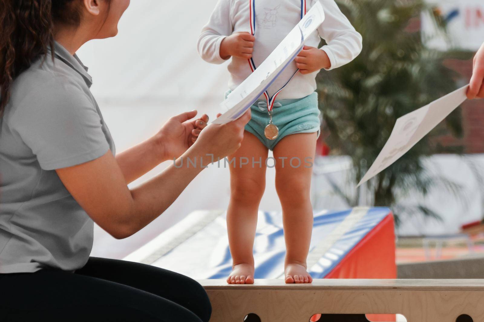 Rewarding a little girl gymnast with a medal