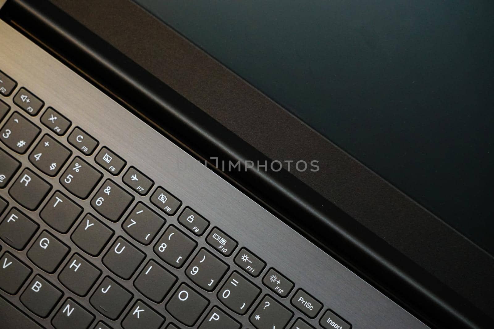 Laptop monitor and keyboard in triangle orientation asymmetric image