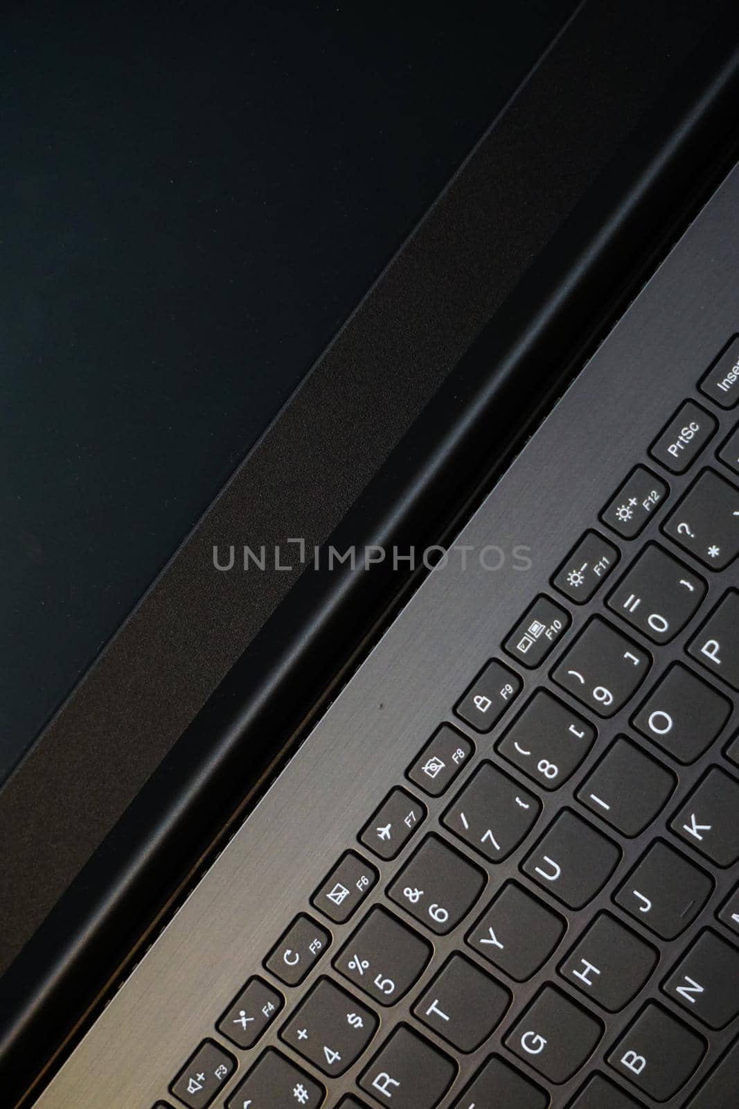 Laptop monitor and keyboard in triangle orientation asymmetric image