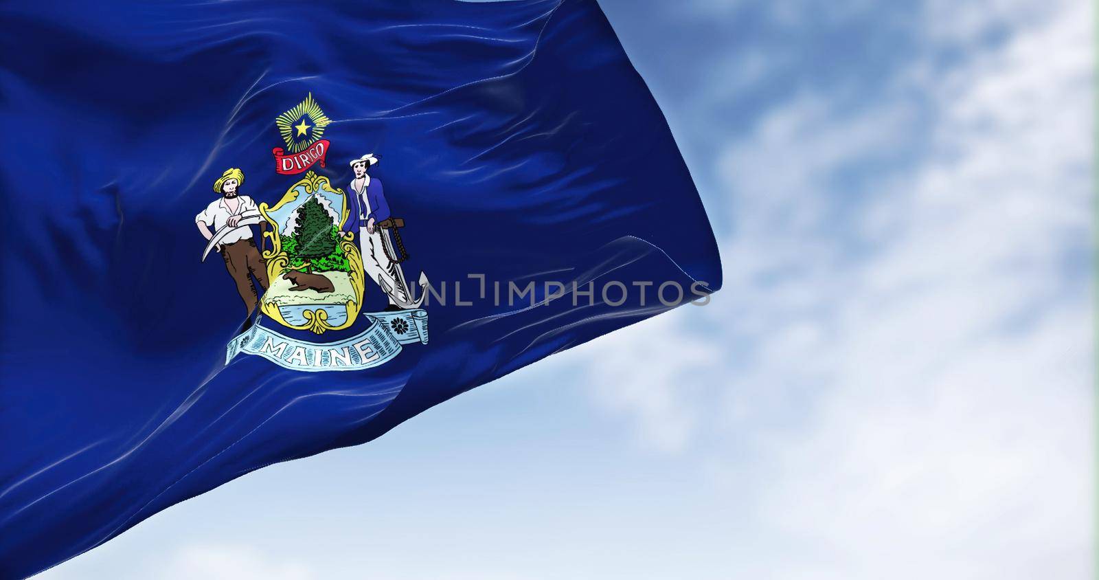 The US state flag of Maine waving in the wind. Maine is a state in the New England region of the United States. Democracy and independence.