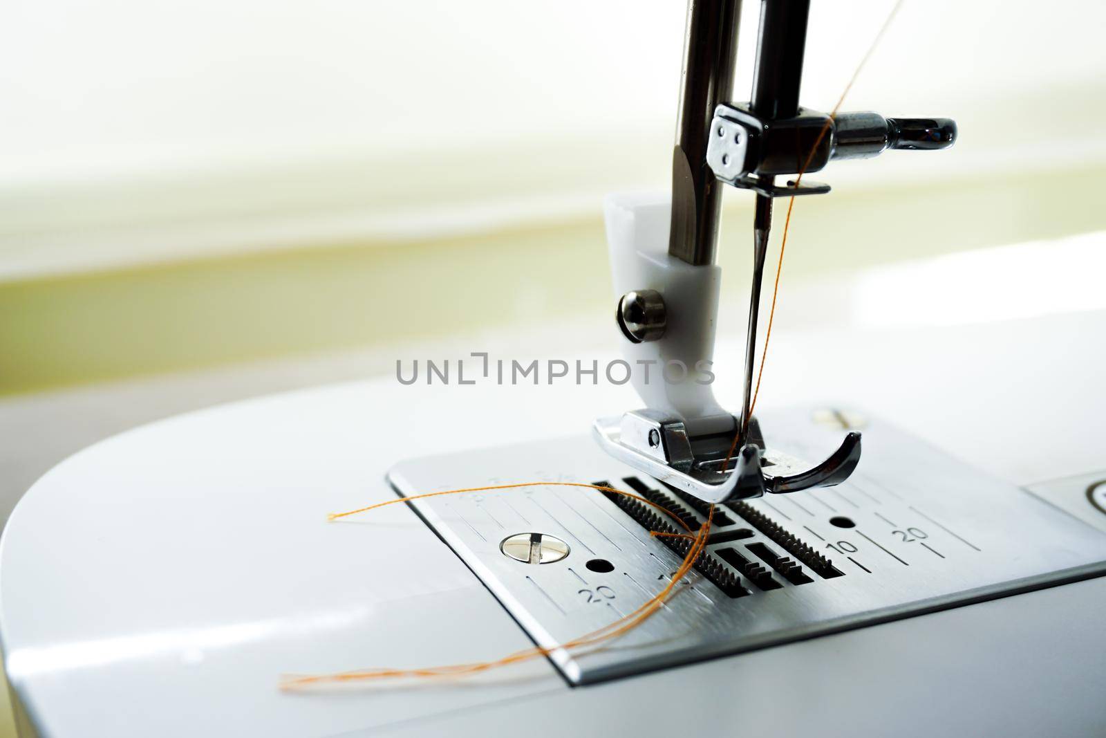 Sewing machine needle bobbin and stitch settings details close up view by tasci