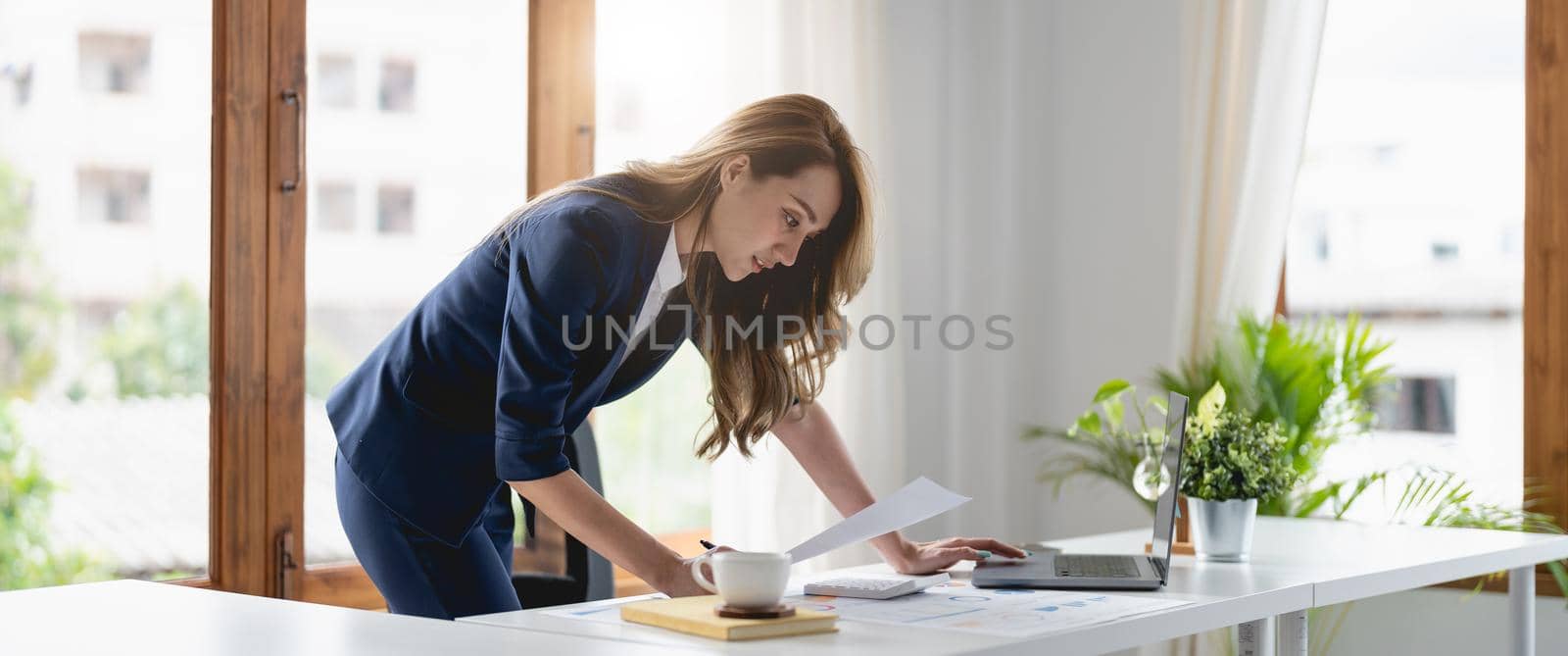 Portrait confident businesswoman asian working at laptop for financial chart report at office