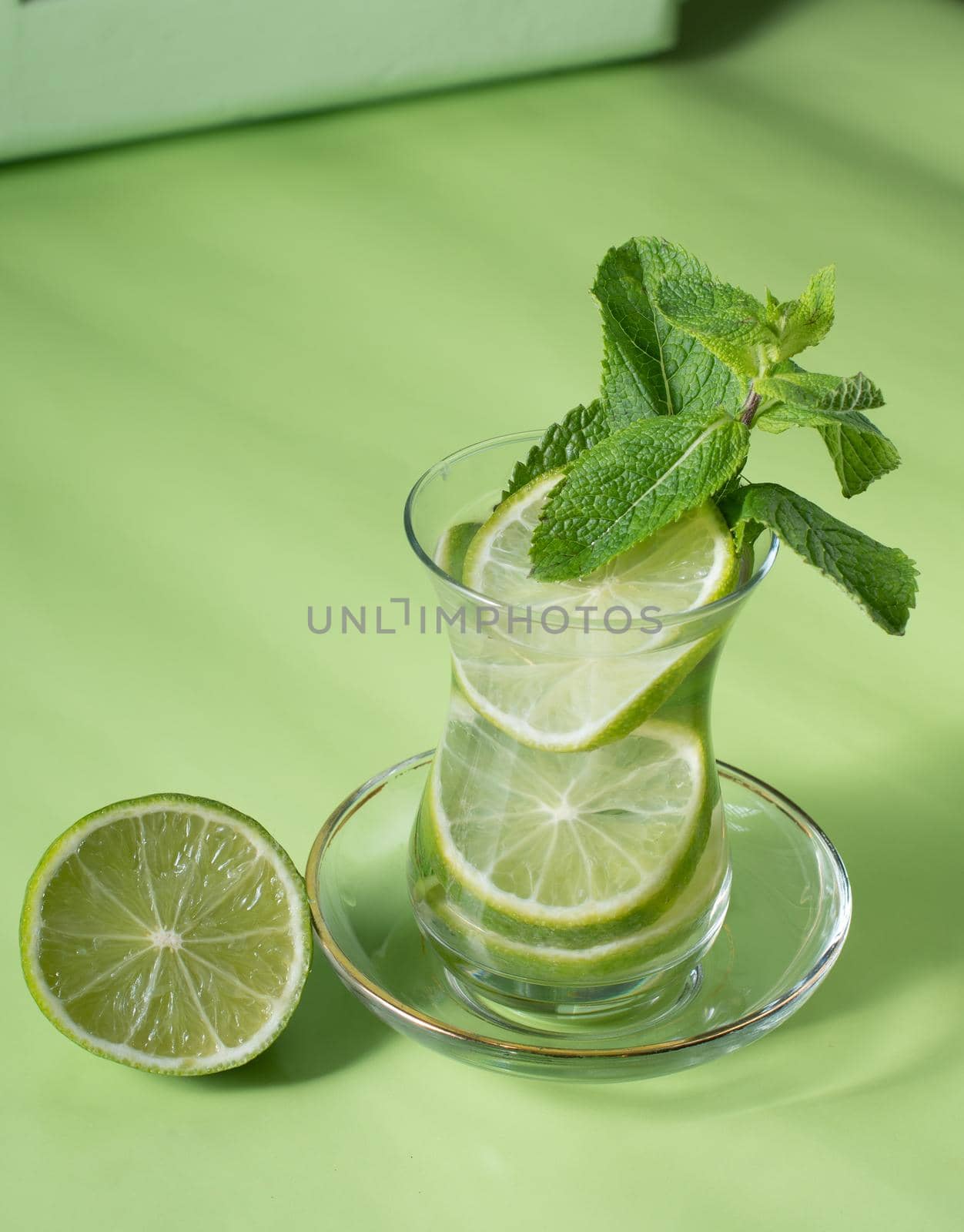tea with mint and lime, with a calming effect, green still life close-up by KaterinaDalemans