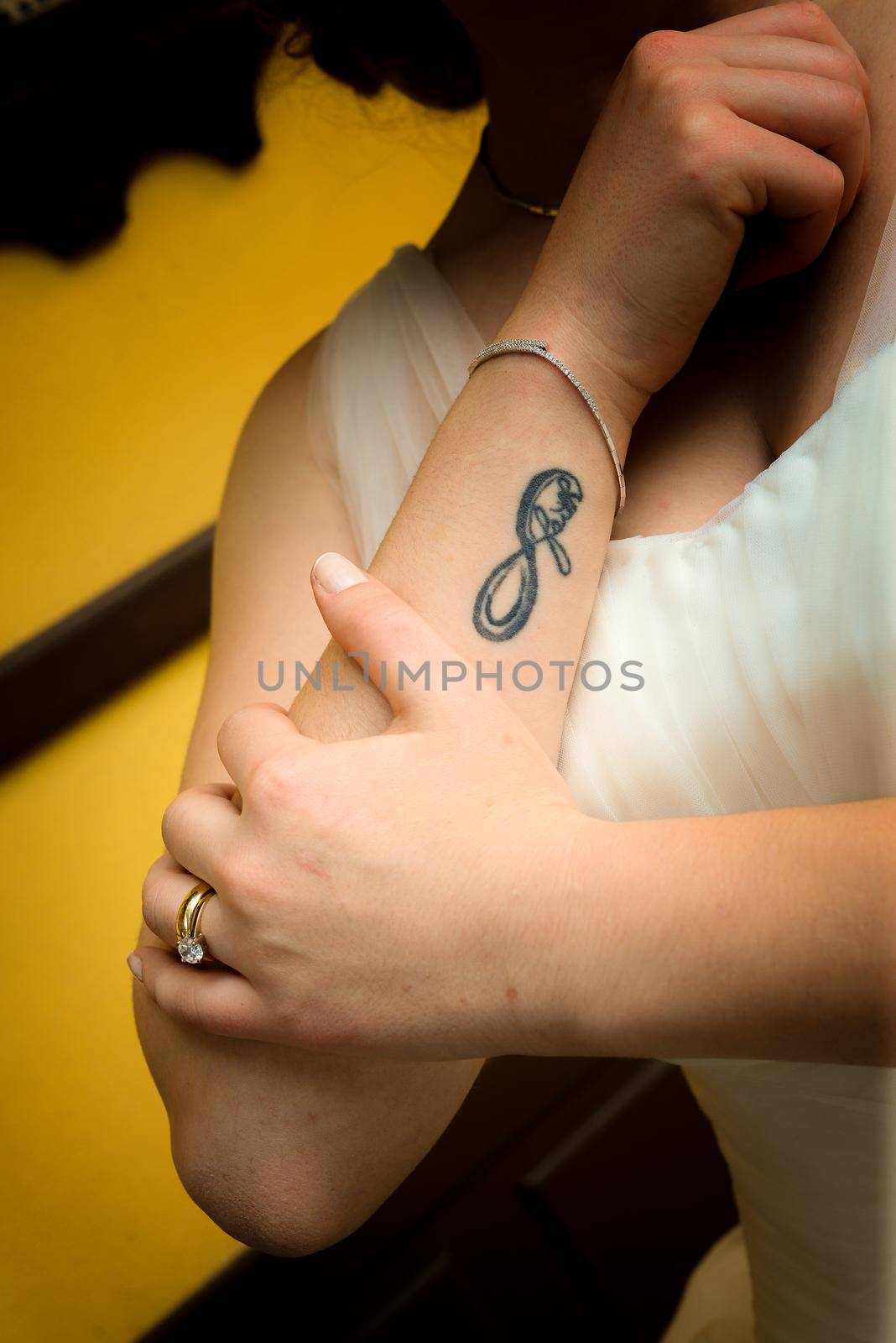 Infınity tattoo on the arm of the bride to be close up view