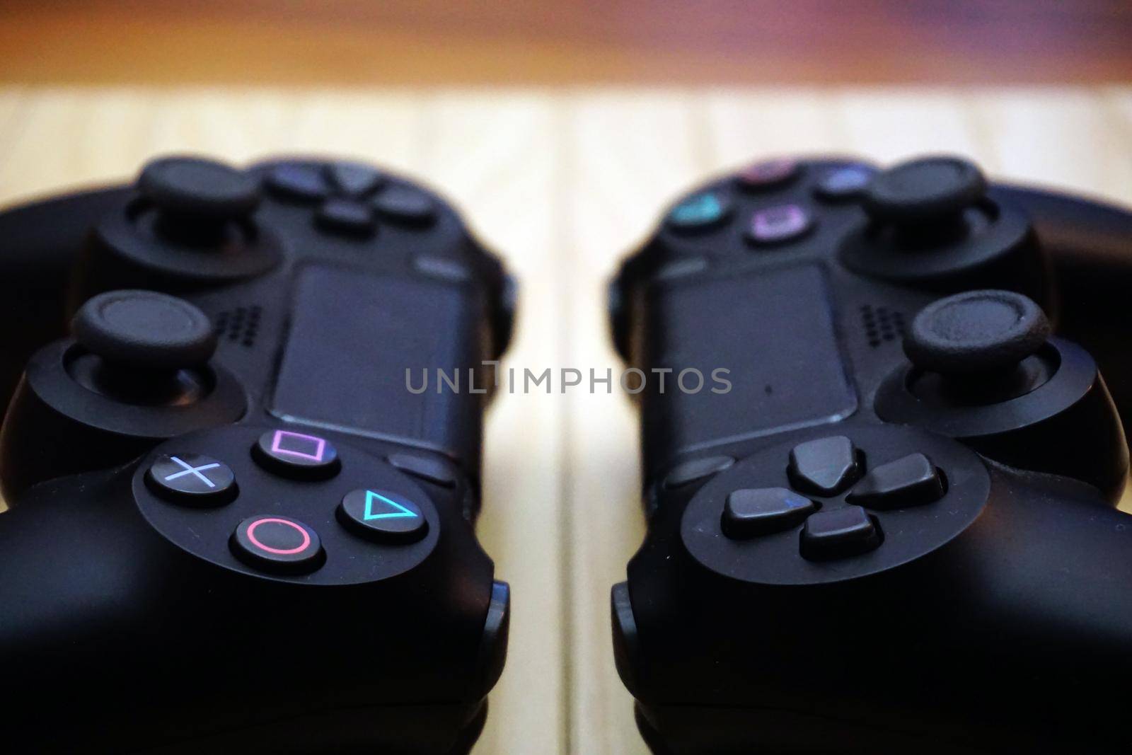 22.03.2019 Eskisehir, Turkey. Two ps4 gamepads on wooden background close up view