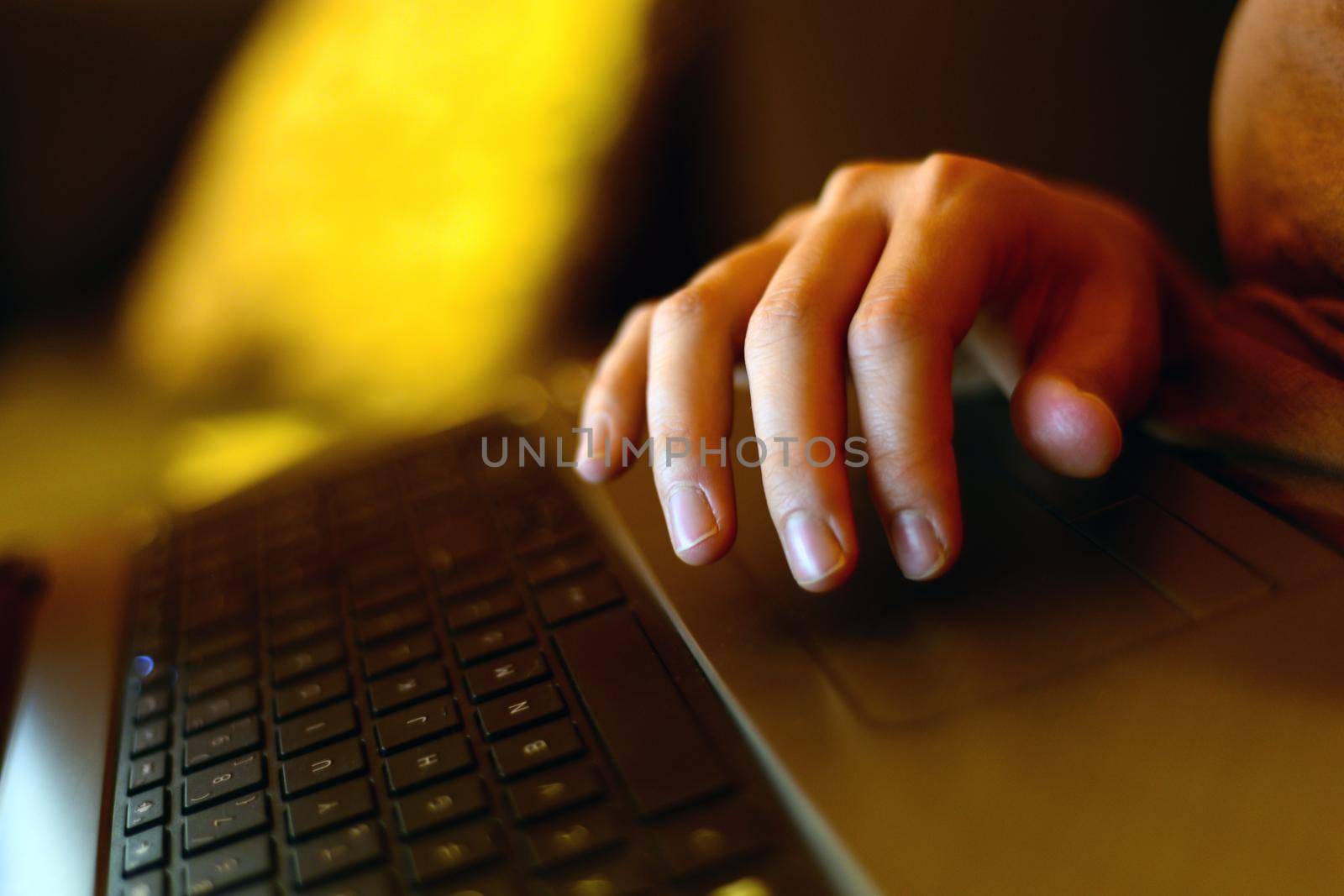 Working on the pc fingers on the laptop computer close up