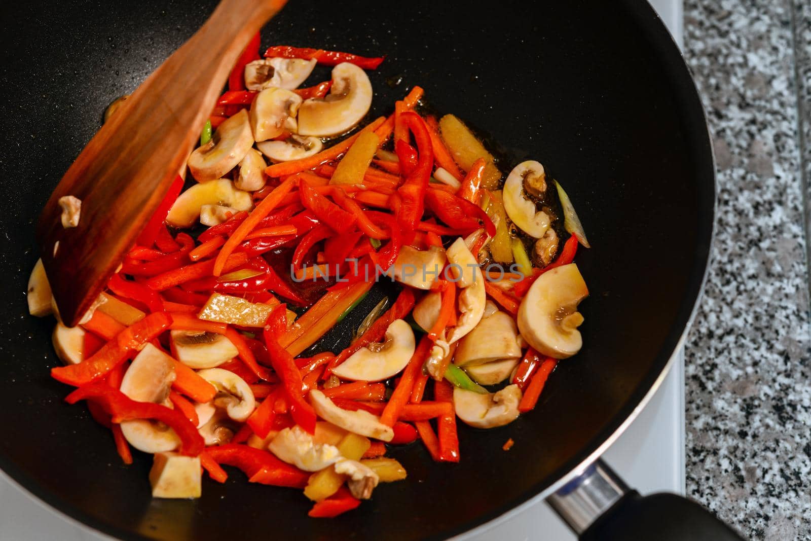 Roasting vegetables in the vok pan close up