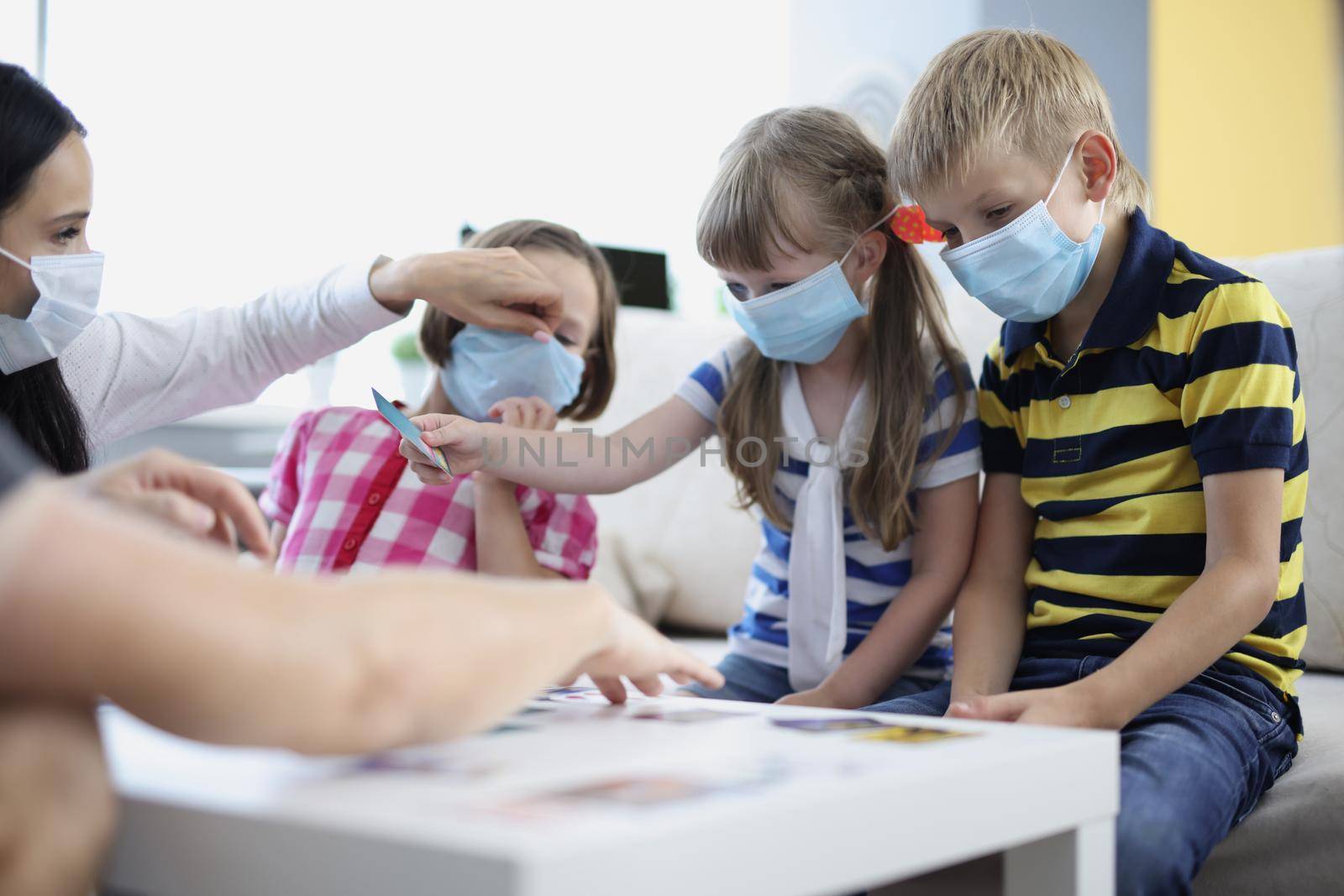 Portrait of woman keep checking on kids health, ask to wear face mask, prevent covid spread. Childhood, quarantine, coronavirus, protection, virus concept