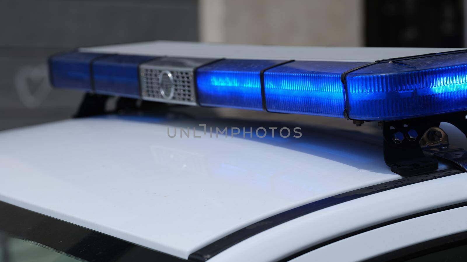 Police lights on car watching traffic on city road. Flashlight on car of ministry of emergency Situations and red blue flashing lights on cars of special forces concept