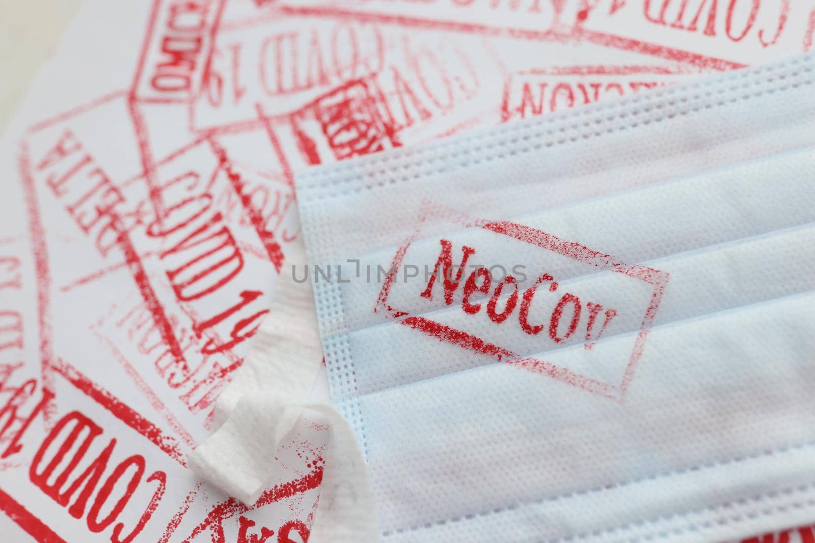Close-up of protective medical face mask with new variant of neocov coronavirus lying on surface. Spread of infection, dangerous virus. Coronavirus concept