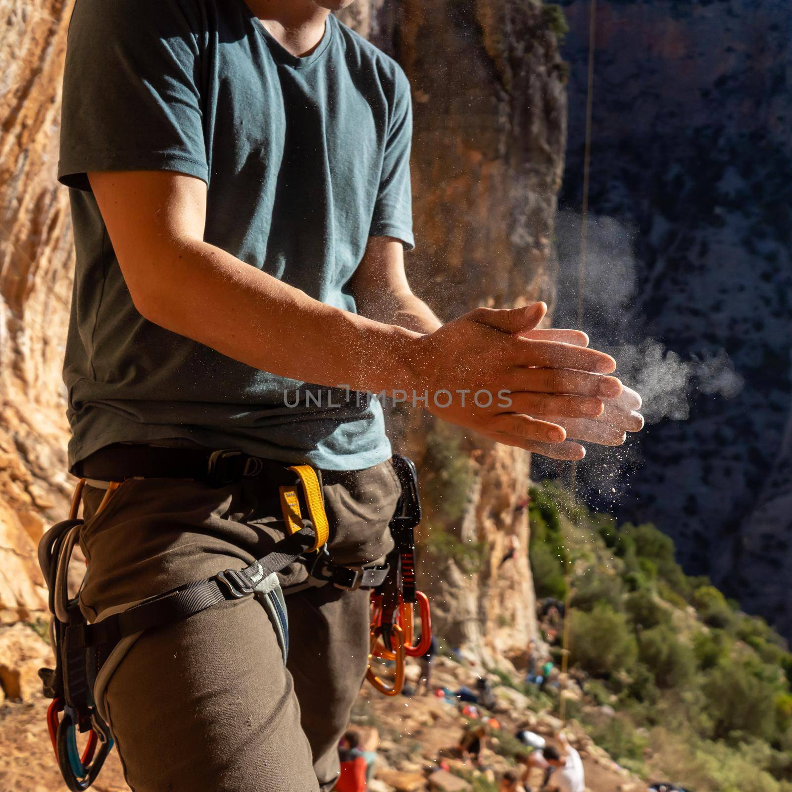 Man climbs with magnesium powder, hands closeup. by africapink