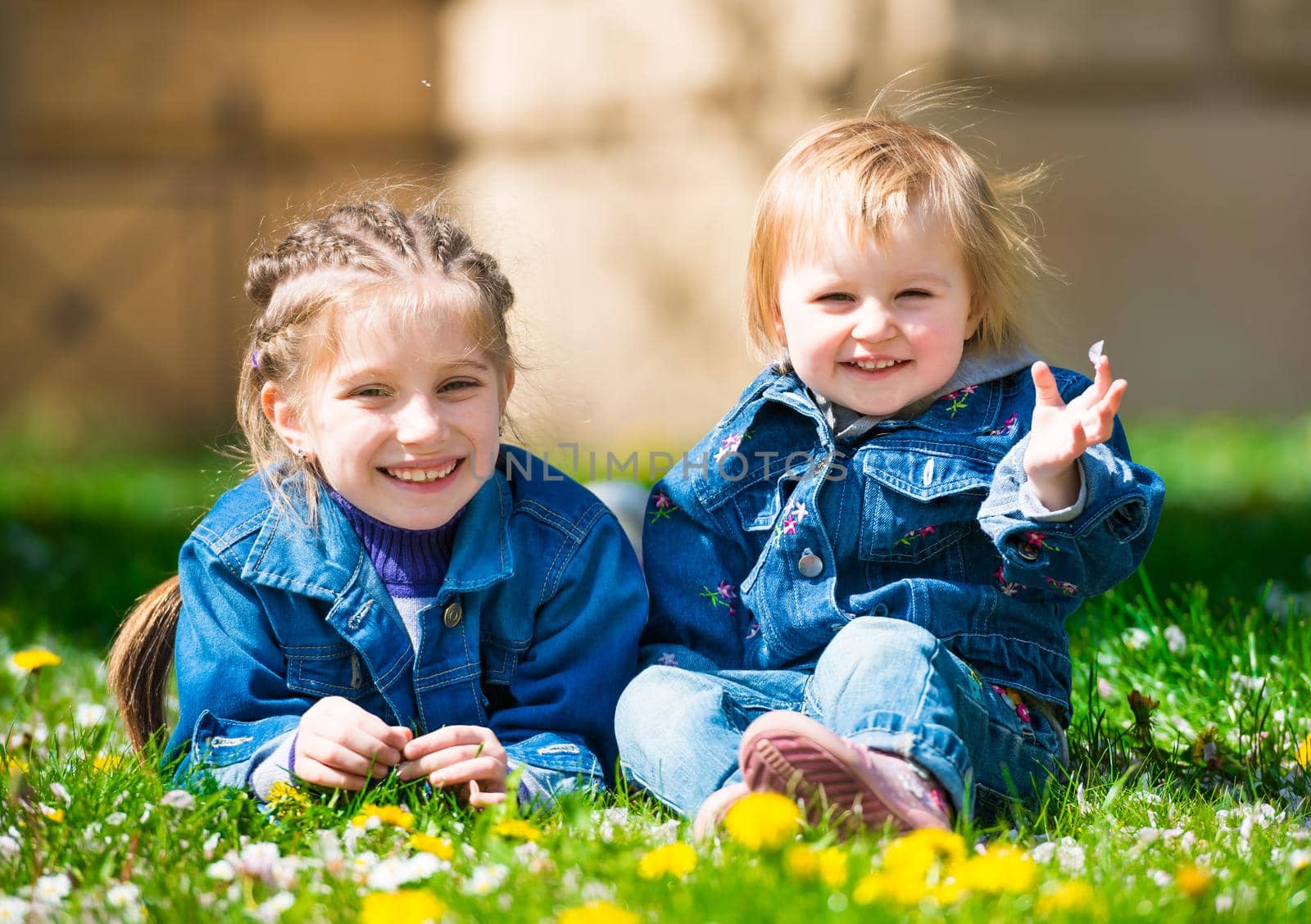 Two sisters in dandelion field