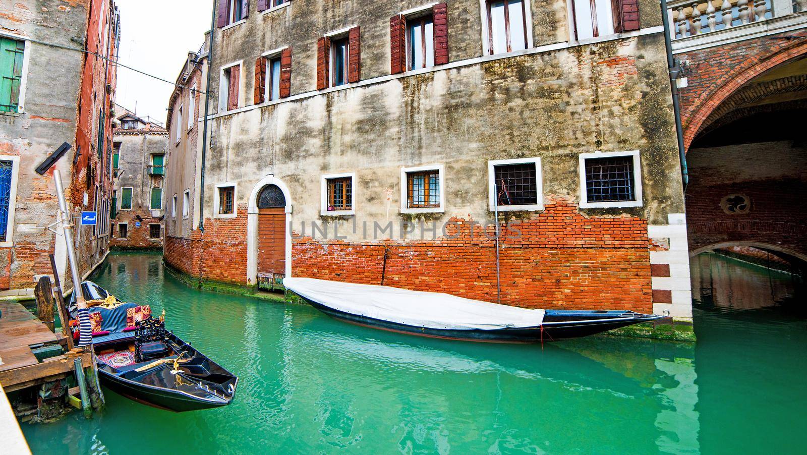 Gondola on Venice canal with houses on the street