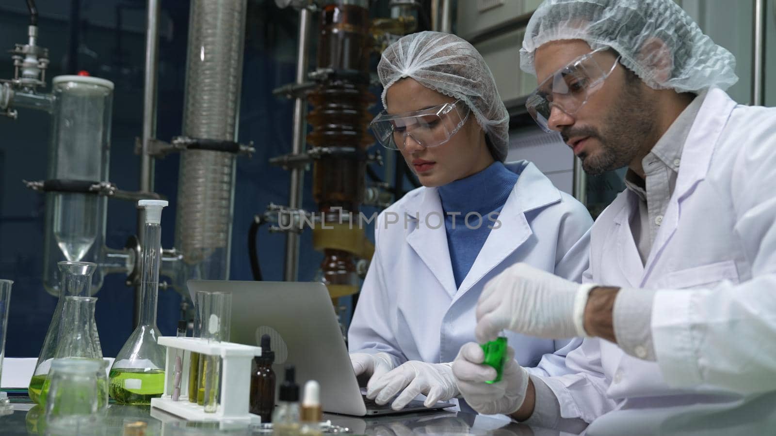 Two scientist in professional uniform working in laboratory for chemical and biomedical experiment