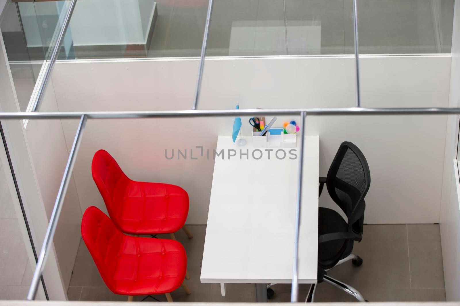 Empty workplace with white table and red chair top view.