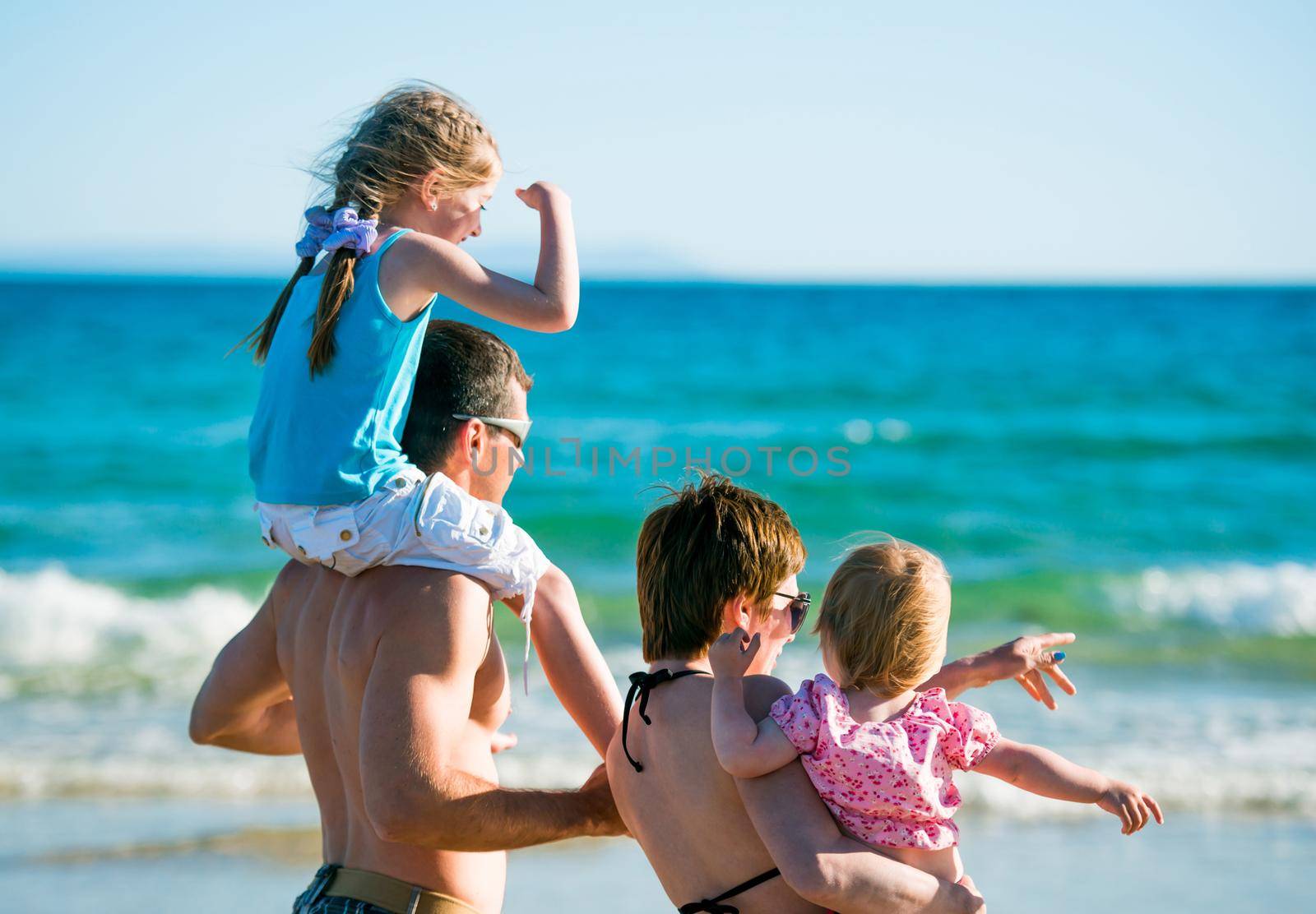 family with child and baby on sea vacation