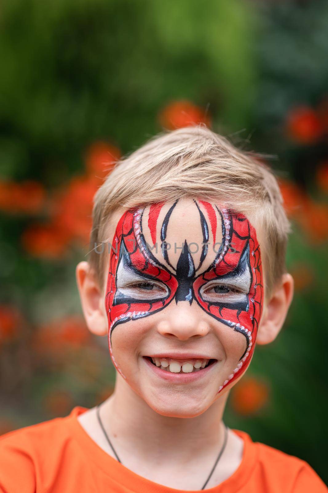 Cute little boy with face paint. Face painting, kid painting face at the birthday party or on holidays