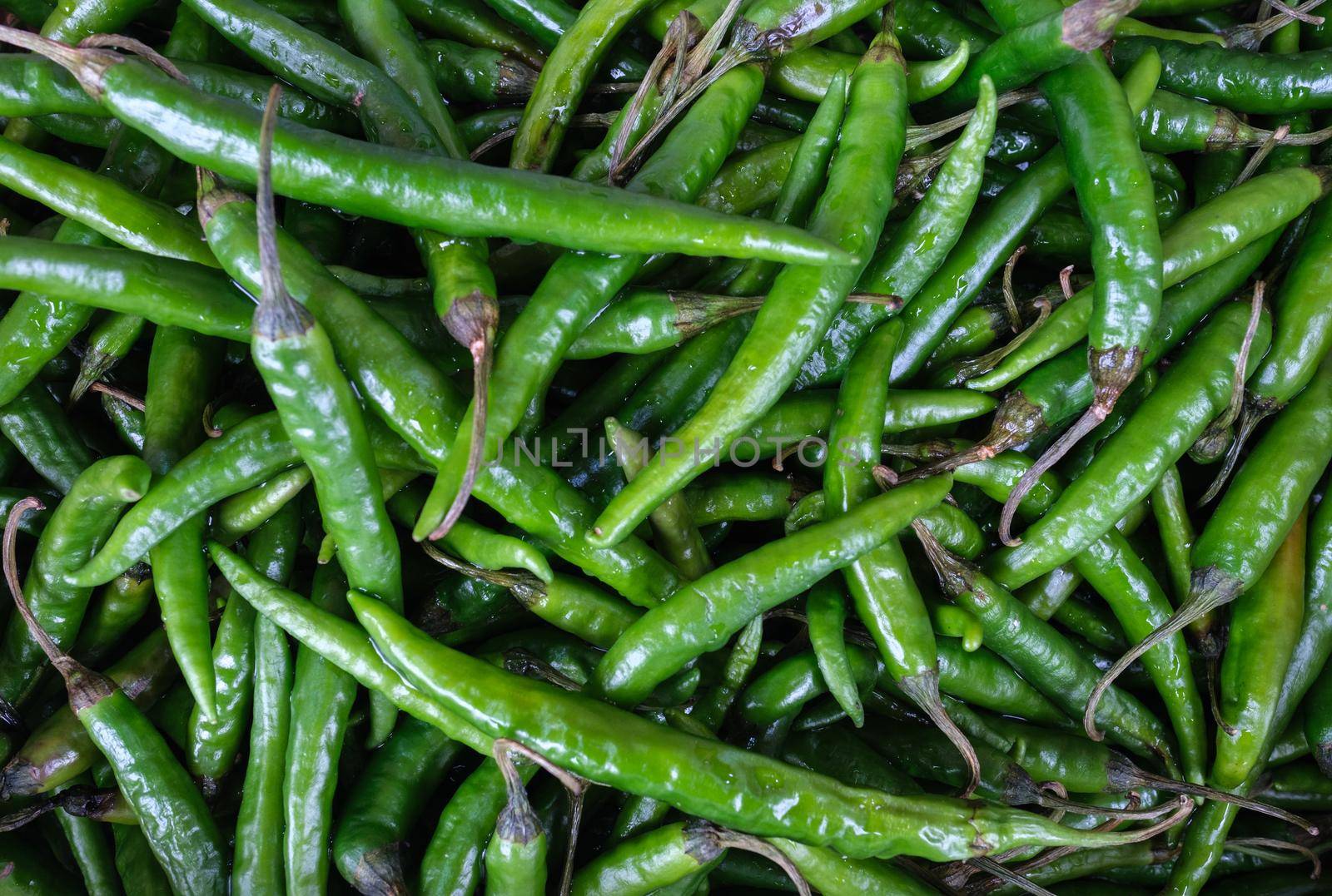 Background Of Green Chili Peppers by mrdoomits