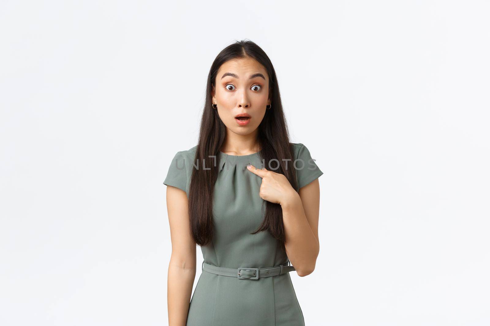 Small business owners, women entrepreneurs concept. Surprised and shocked asian woman in dress pointing at herself with startled face, being chosen or picked, standing white background speechless.