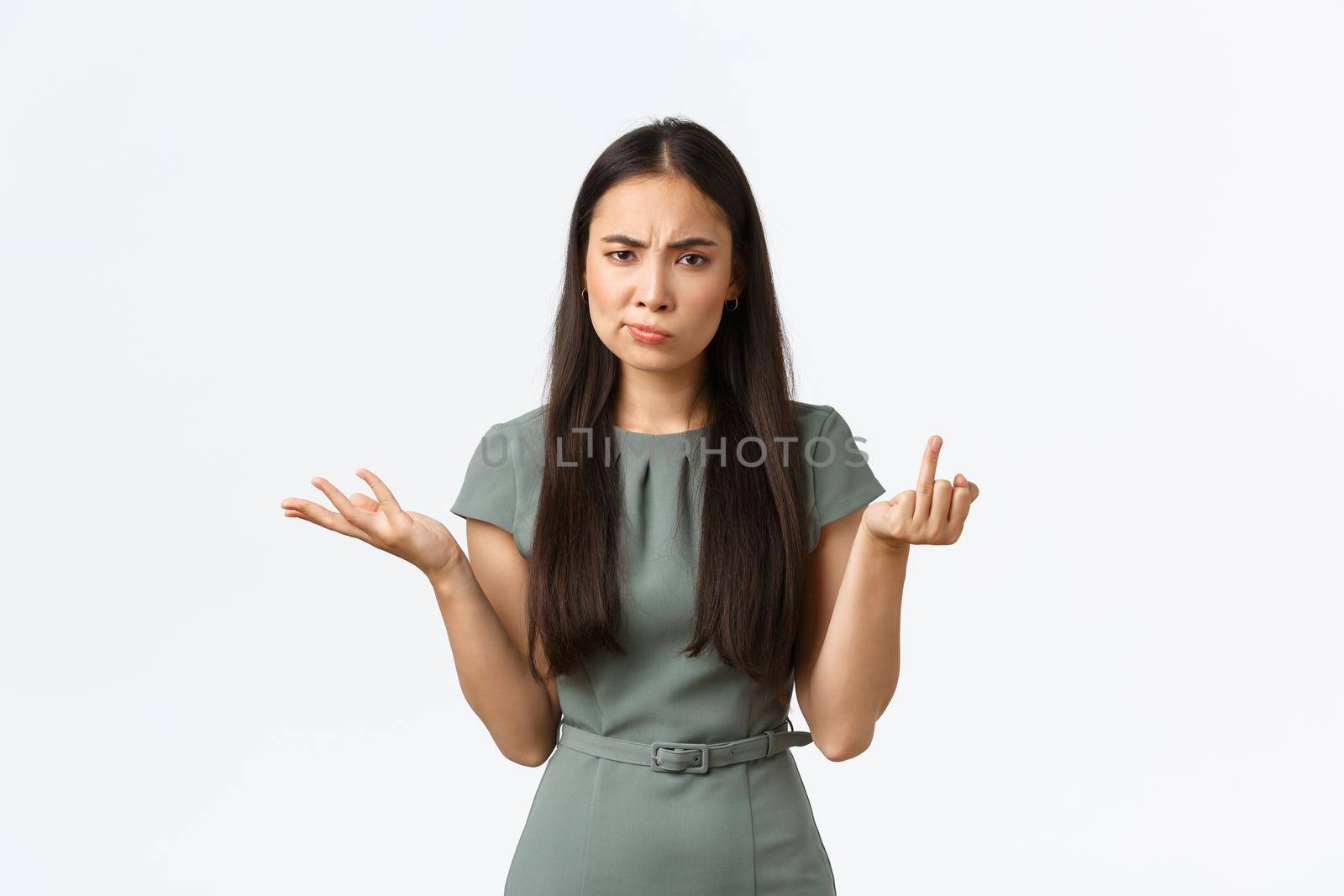 Small business owners, women entrepreneurs concept. Confused and displeased asian woman cant understand why boyfriend not making proposal, showing finger without wedding ring and shrugging.