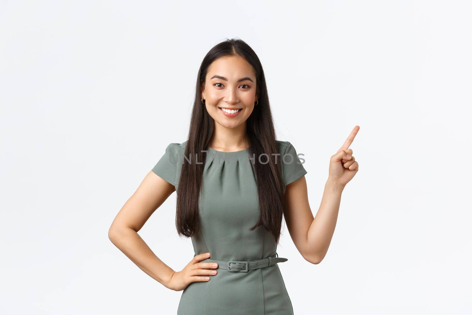 Smiling asian female real estate agent showing apartment, perfect deal for best price. Woman pointing finger upper right corner, businesswoman make demonstration, white background.
