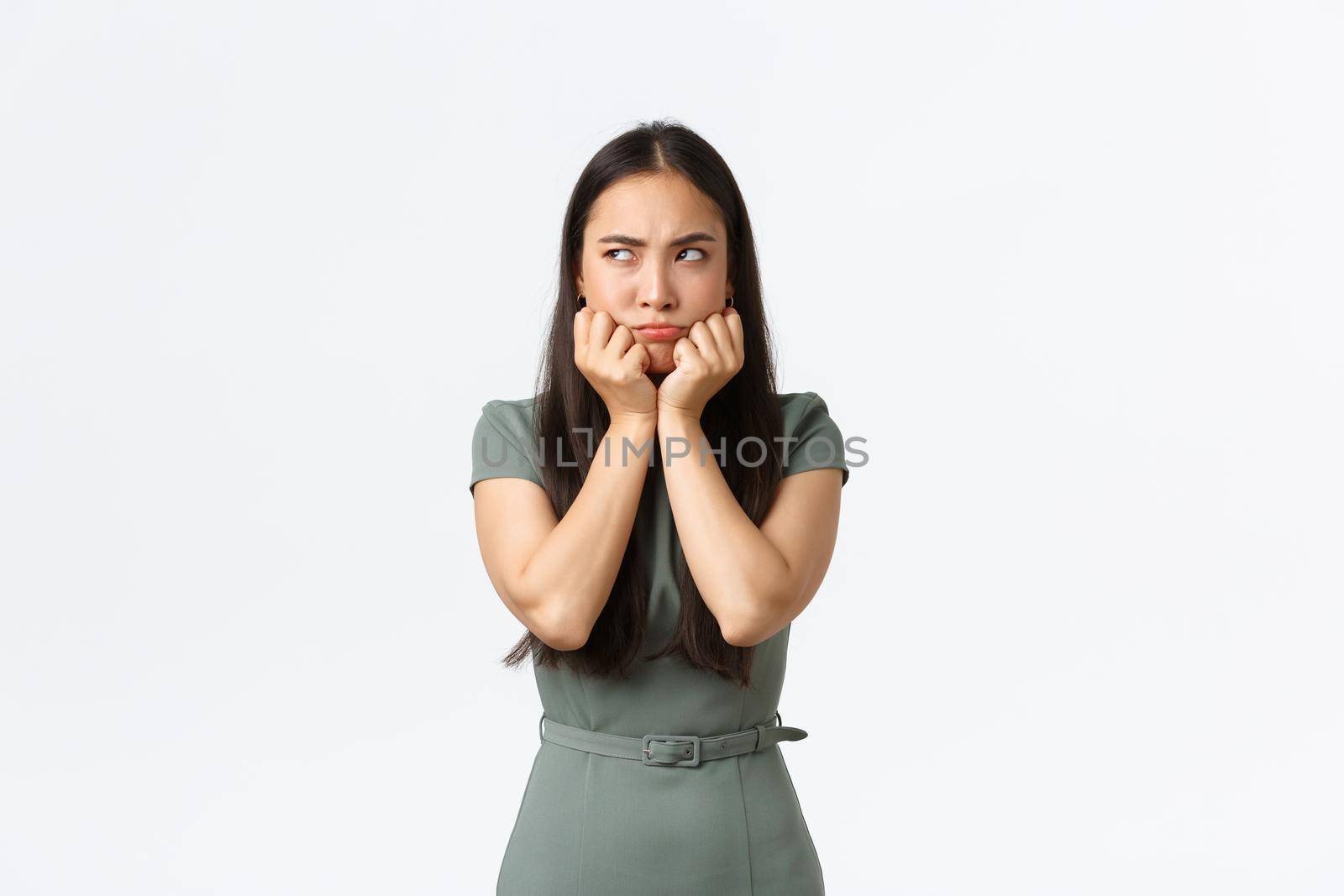 Small business owners, women entrepreneurs concept. Pouting moody asian girlfriend acting childish as looking left offended, sulking over argument or confrontation with boyfriend, white background.