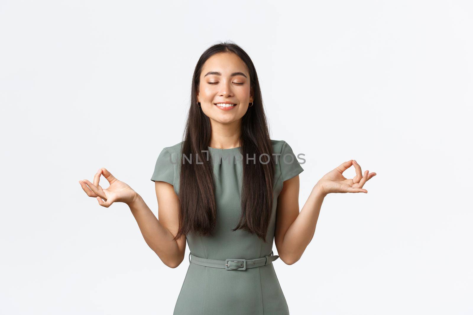 Small business owners, women entrepreneurs concept. Relaxed and peaceful smiling asian businesswoman feeling relieved after taking antidepressants, meditating, doing yoga exercise.
