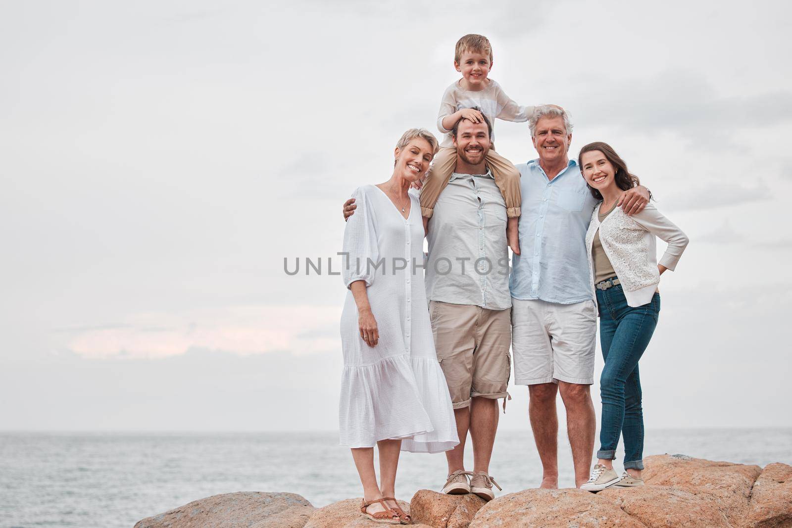 For my family, Ill travel to the ends of the earth. a happy family enjoying a day along the coast