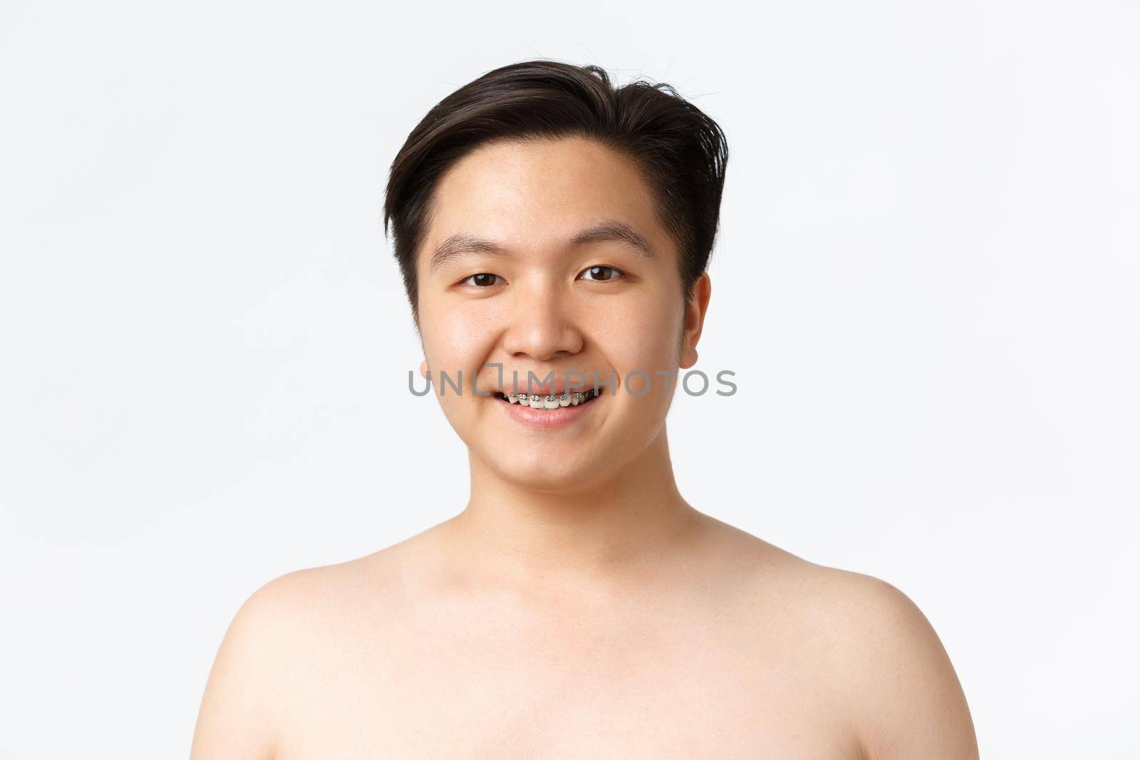 Beauty, skincare and hygiene concept. Close-up of smiling asian guy with braces standing naked over white background, advertisement of dermatology products, cleansers for acne prone skin by Benzoix