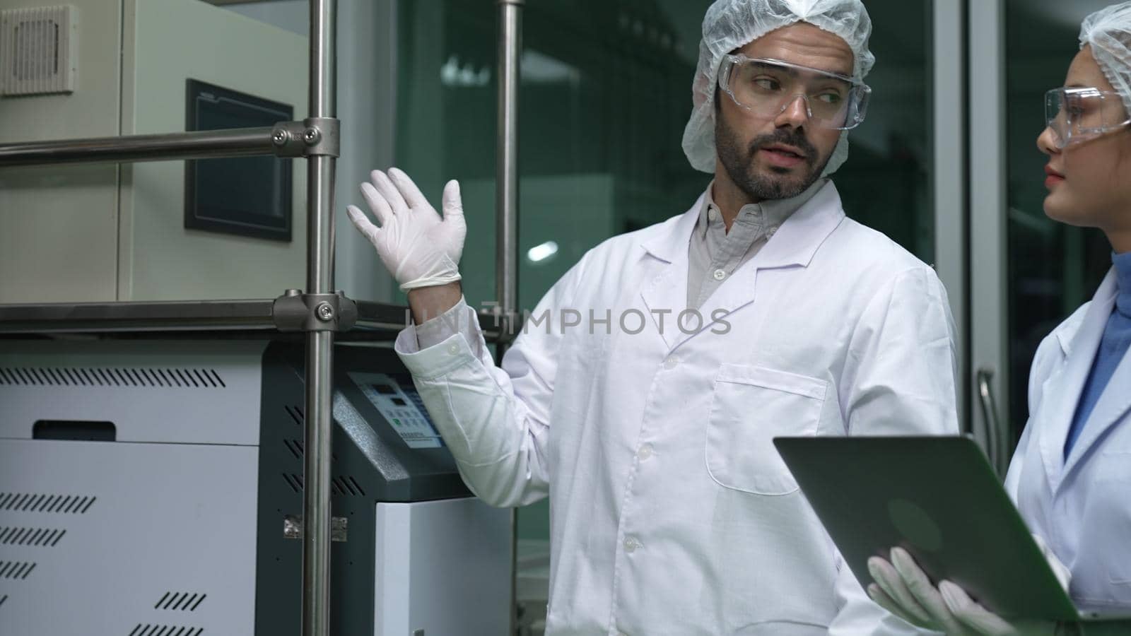 Two scientist in professional uniform working in laboratory for chemical and biomedical experiment