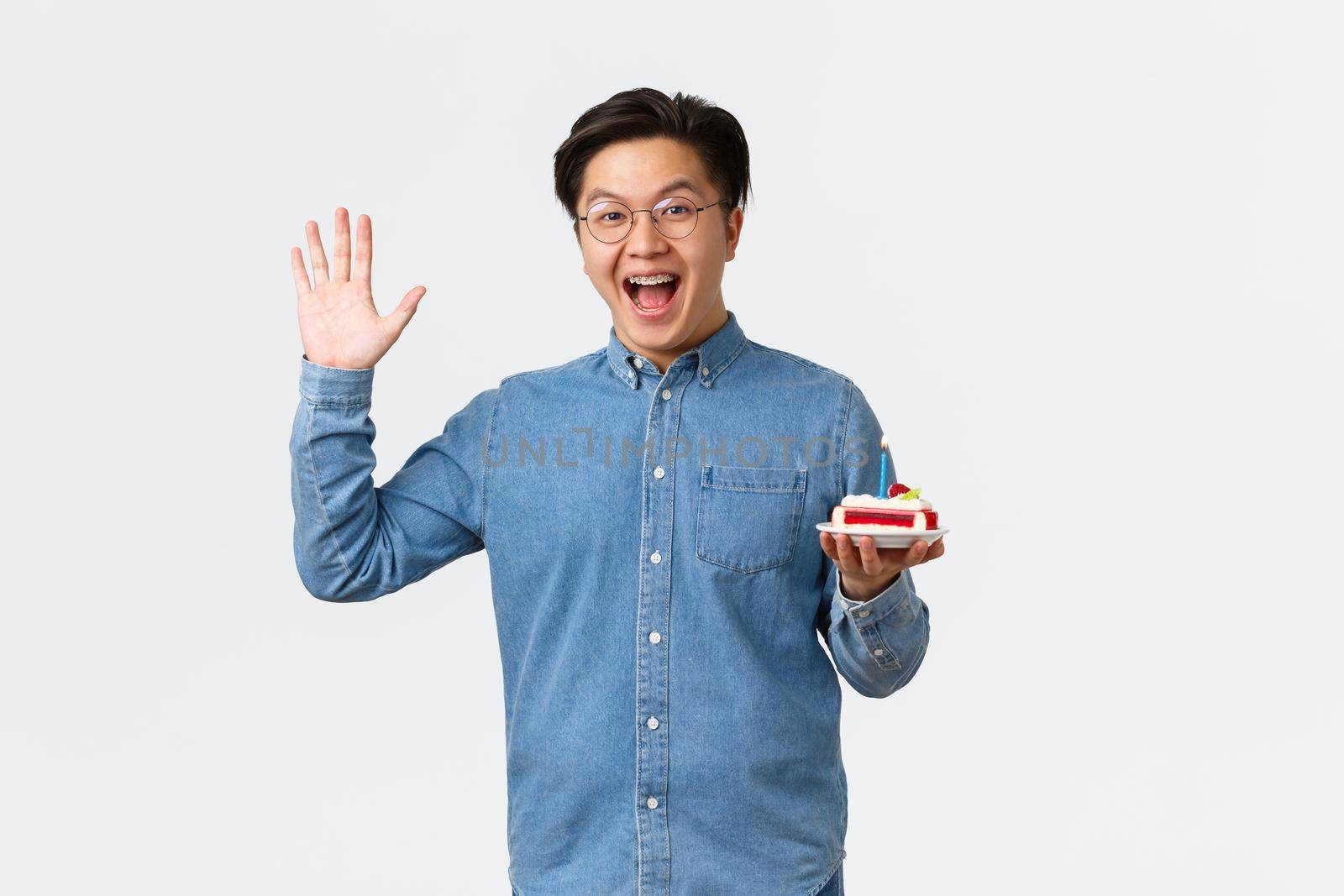 Celebration, holidays and lifestyle concept. Friendly happy guy waving hand to say hello and bring birthday cake to person celebrating, enjoying b-day party, standing upbeat white background by Benzoix