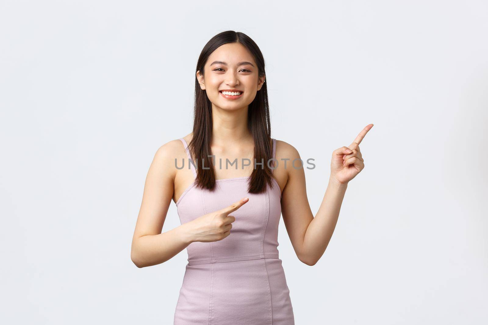 Luxury women, party and holidays concept. Cheerful attractive female student at prom night showing way. Gorgeous girl in evening dress pointing fingers right and smiling, invite see event by Benzoix