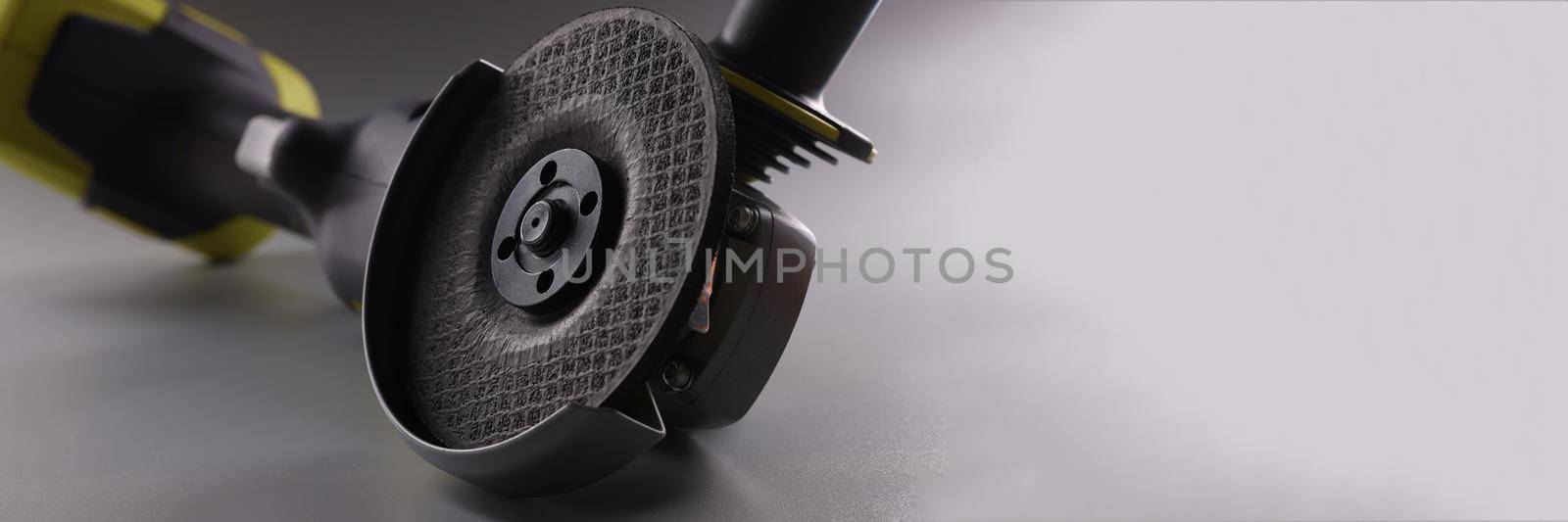 Angle pneumatic grinders grinder with a disc on a gray background by kuprevich