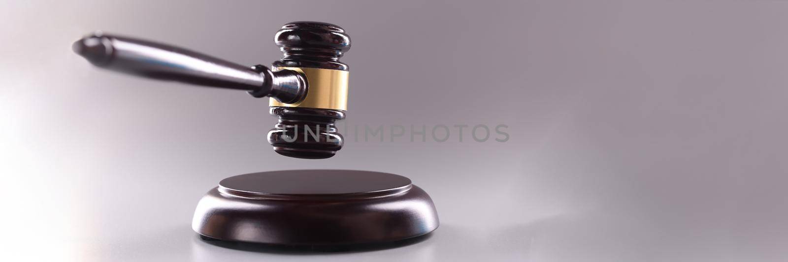 Wooden judge gavel on a gray background by kuprevich