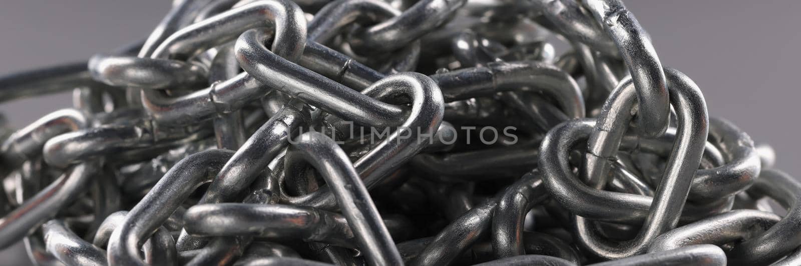 Chrome plated metal chain on gray background. Strong metal chain chain links concept