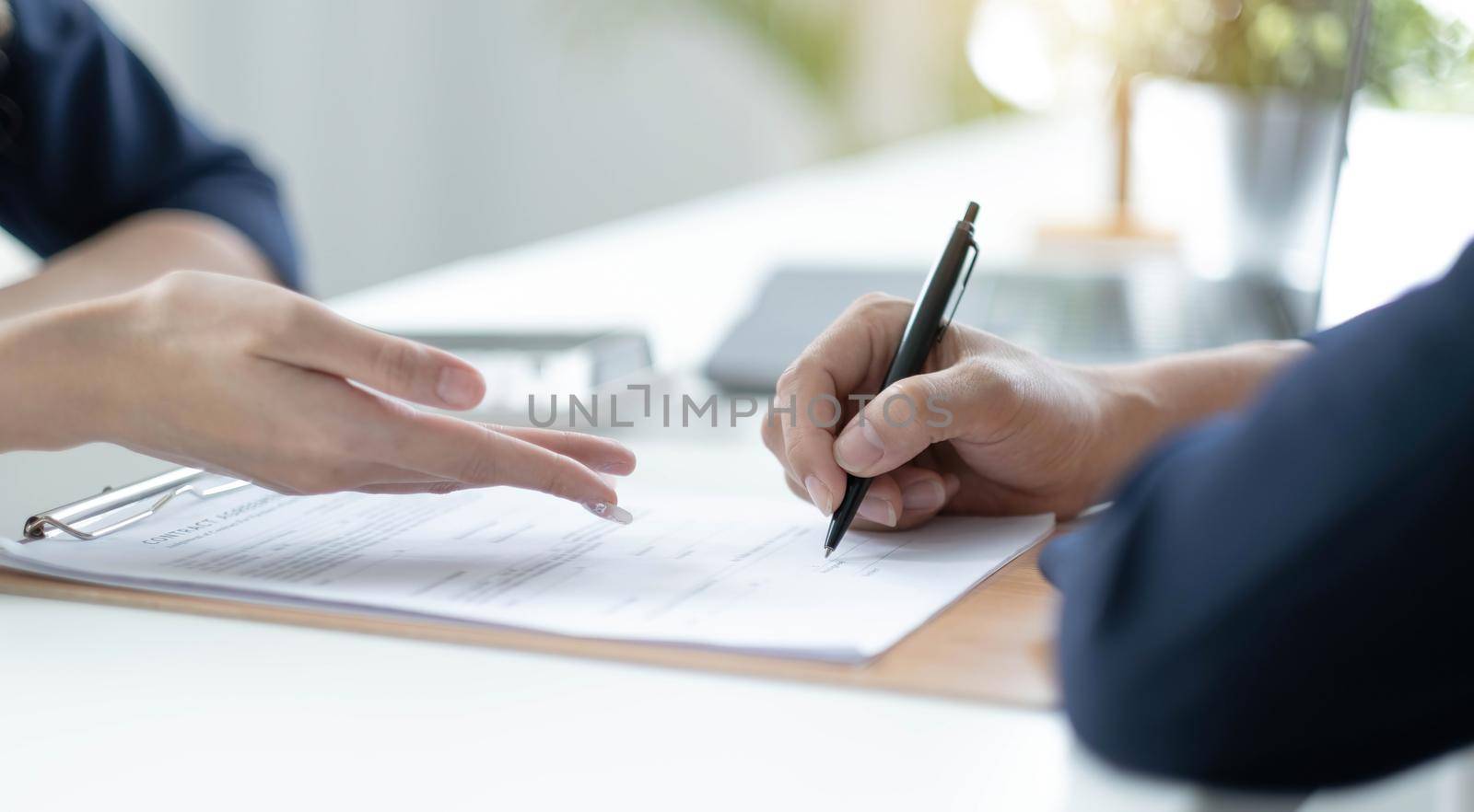 Close up of male hand putting signature, running own small business, have a contract in place to protect it, basics of writing contract, one sentence in a contract can cost a business..