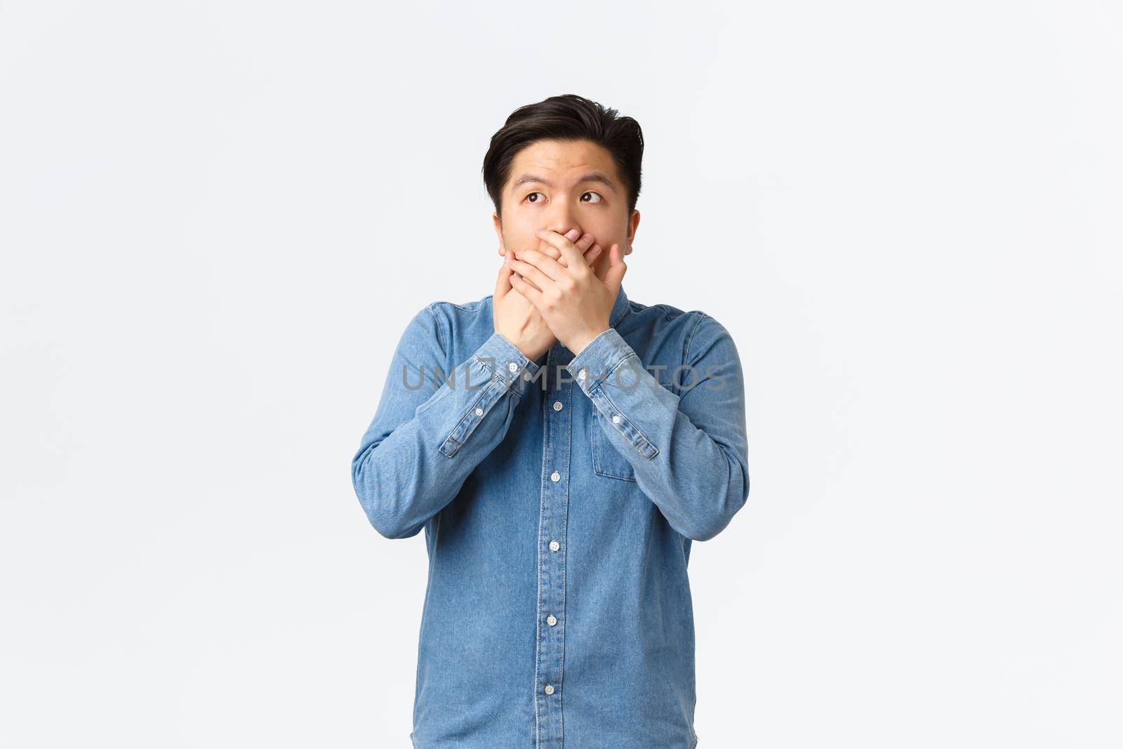 Shocked and speechless asian guy witness something, cover mouth with hands and looking upper left corner, gasping astounded with revelation, hear stunning gossip, white background by Benzoix