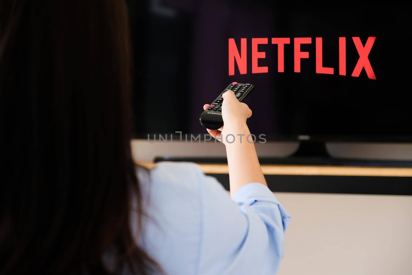 Chiang mai Thailand, 2020 June 07 - A young woman watches Netflix on his TV and at home. by Manastrong