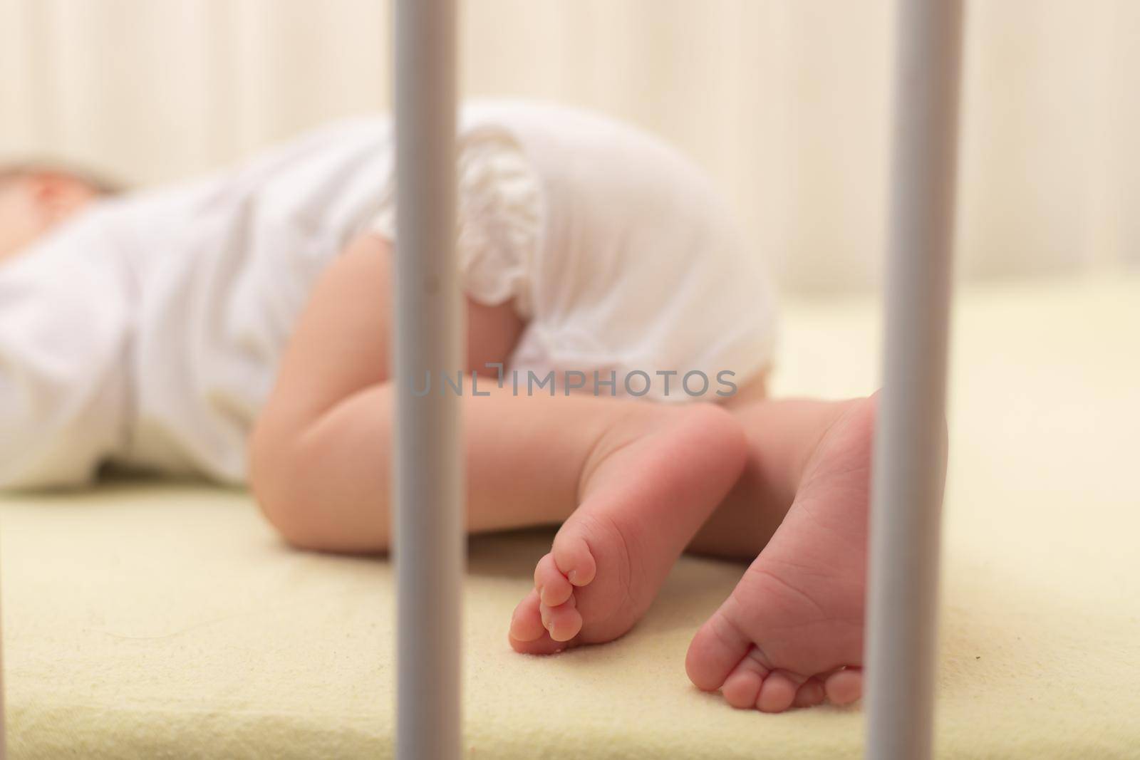 The baby sleeps in the copy space crib . Advertising of children's goods. Illustrating children's articles. A small child. A newborn. A child's dream.