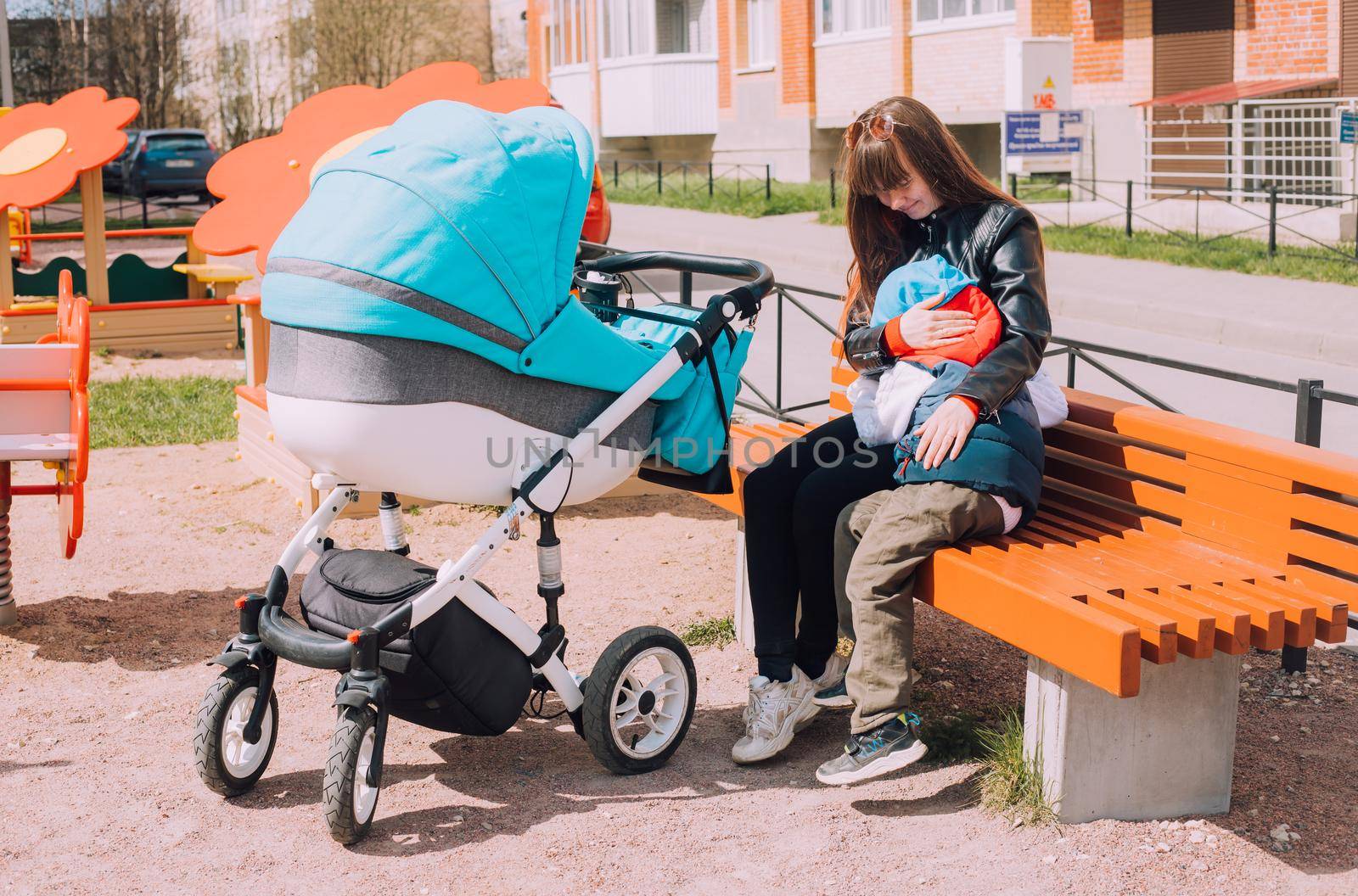 Mom on a walk with children lifestyle . An article about walking with children. An article about jealousy of a new child. by alenka2194
